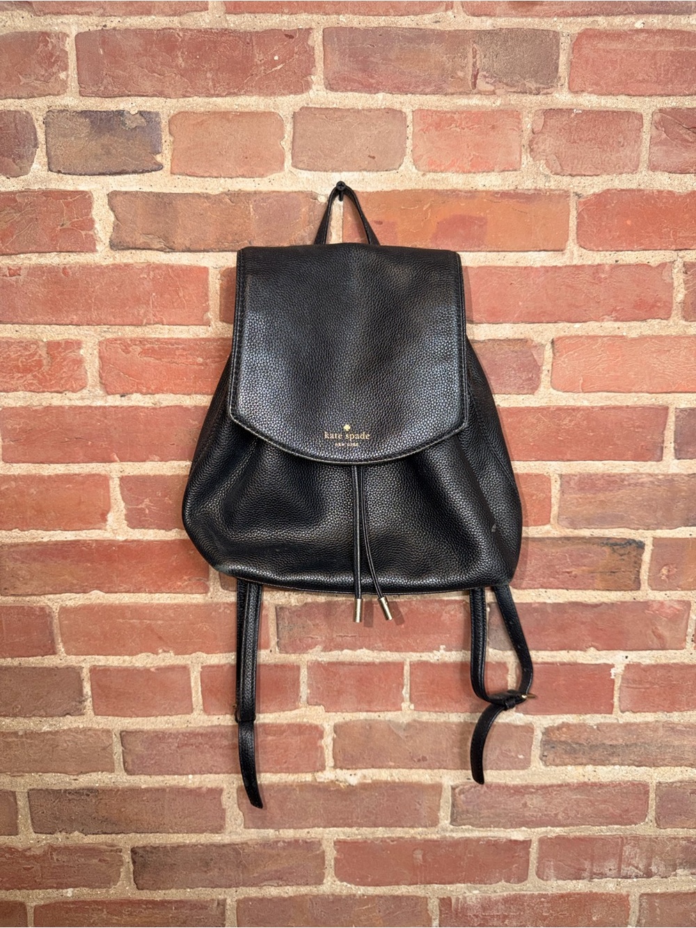 kate spade black pebbled leather flap drawstring backpack